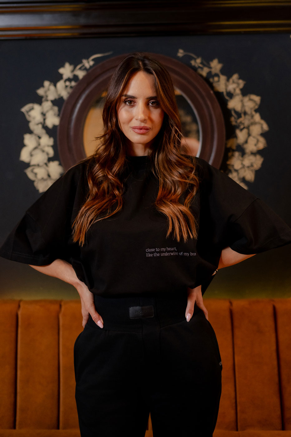 Women's NOIRD black cotton t-shirt, front view with black trousers